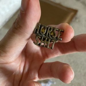 Vintage 70s horseshit pin.